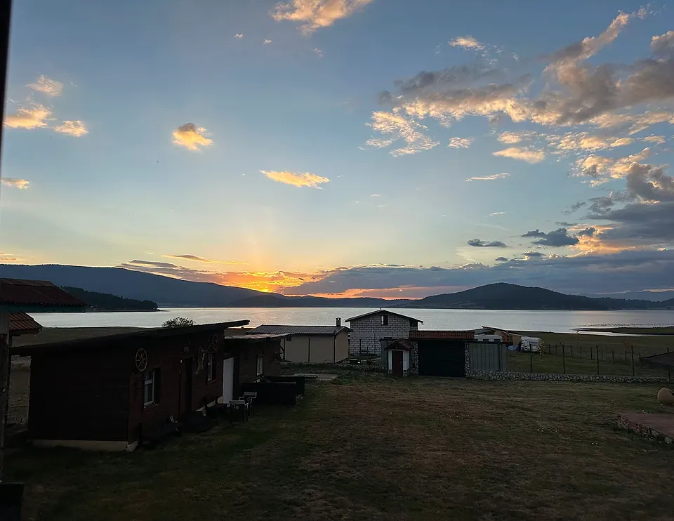 Бреговите къщи на Batak Bay Village и залез над язовир Батак